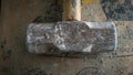 Close up view of abandon big steel hammer at construction site on cement bag
