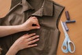 Close up view from above on the hands of a dressmaker