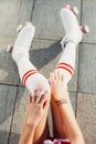 Close up view from above of woman`s legs in a vintage roller skates, golfs. Royalty Free Stock Photo