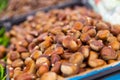 Close-up view of abundance of chestnuts in crate