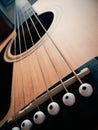 Close-up view of acoustic guitar strings and the bridge Royalty Free Stock Photo