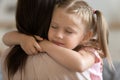 Closeup view adorable daughter closed eyes embraces loving mother Royalty Free Stock Photo