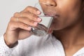 Close up view african female drinking still water quenches thirst