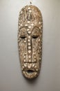 Close up view of african wall mask on gray wall background isolated. Interior concept