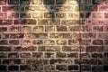 Close up view at an aged brick wall with some bright colored spot lights