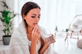 Close up view of ailing woman drinks pills