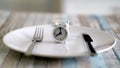 Close up view of alarm clock on a plate intermittent fasting diet concept , time to eat healthy lifestyle Royalty Free Stock Photo