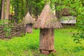 Close-up view of an ancient bee hive. It made from a trunk of old tree with a thatched roof.