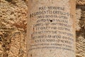 Close up of Latin inscribed column at the ancient ruins of Capernaum