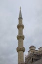 Close-up view of ancient minaret against cloudy sky. Minaret of the mosque of Hagia Sophia in Sultan Ahmed Park Royalty Free Stock Photo