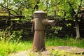 Close-up view of ancient rusty column covered by moss for distribution of drinking water. Dispenser. Pump for water. Royalty Free Stock Photo