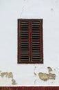 Close up view of ancient wooden shutters on the old white cracked wall. Balatonfoldvar, Hungary Royalty Free Stock Photo