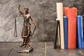 Close-up view of antique statue of lady justice and books Royalty Free Stock Photo