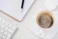 close up view of arranged computer keyboard, mouse, cup of coffee and papers on table Royalty Free Stock Photo