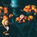 close up view of arrangement of fresh lemons and tangerines in bowl and strainer on table