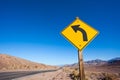 Close-up view of arrow yellow road sign in desert