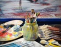 Close-up view of artist workplace with paints brushes and palette on an black  background, Royalty Free Stock Photo