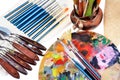 Close-up view of artist workplace with paints brushes and palette on an isolated white background Royalty Free Stock Photo