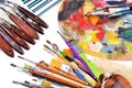 Close-up view of artist workplace with paints brushes and palette on an  white background Royalty Free Stock Photo