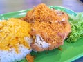 Asian curry sauce on white rice with fried chicken