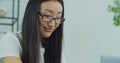 Close up view of Asian woman eyes with glasses freelancer works in home on laptop. Happy girl use computer for study Royalty Free Stock Photo