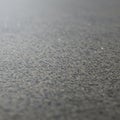 Close-up view of an asphalt or concrete surface. The texture is rough, with small, Royalty Free Stock Photo