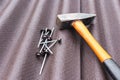 Close up view on asphalt roofing shingles background with hammer and nails Royalty Free Stock Photo