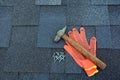 Close up view on Asphalt Roofing Shingles Background. Roof Shingles - Roofing. Asphalt Roofing Shingles Hammer, Gloves and Nails Royalty Free Stock Photo