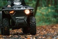 Close up view. ATV driver is in the forest, having a ride at daytime Royalty Free Stock Photo