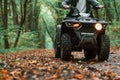 Close up view. ATV driver is in the forest, having a ride at daytime Royalty Free Stock Photo