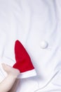 Close-up view of baby boy`s legs on red Santa Claus hat. First Christmas of a newborn baby Royalty Free Stock Photo