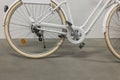 Close up view of back wheel of white bicycle with protection for clothes on chain. Royalty Free Stock Photo