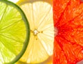 Close up of backlit lime lemon and grapefruit slices with vibrant colors citrus Royalty Free Stock Photo