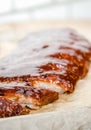 Close up view of barbecue ribs with fries and sauce on a old wooden table