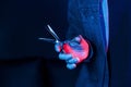 Close up view of barber`s hands that holding scissors. Neon lighting