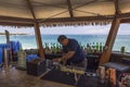 Close-up view of barman making alcohol cocktail in outdoor restaurant on coast of Atlantic Ocean.