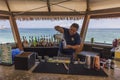 Close-up view of barman making cocktail in outdoor restaurant on coast of Atlantic Ocean.