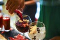 Close up view of barmans hand pouring glass from a bottle into cocktail glass Royalty Free Stock Photo