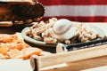 close-up view of baseball bats, baseball ball on plate with peanuts, snacks and leather glove on wooden table with us flag Royalty Free Stock Photo