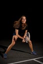 Close-up view on beautiful athletic woman with racket in special pose which preparing to hit tennis ball Royalty Free Stock Photo