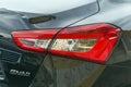 Close up view beautiful design of red tail light of Maserati Ghibli car in gunmetal color, produced by Italian Maserati automotive