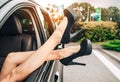 Close up view of beautiful female legs on the high heels through the window of the car at the parking lot Royalty Free Stock Photo