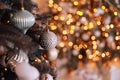 Close up view of beautiful fir branches with shiny golden bauble or ball, xmas ornaments and lights, Christmas holidays Royalty Free Stock Photo