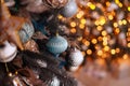 Close up view of beautiful fir branches with shiny golden bauble or ball, xmas ornaments and lights, Christmas holidays Royalty Free Stock Photo