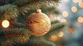 Close up view of beautiful fir branches with shiny golden bauble or ball, xmas ornaments and lights, Christmas holidays background Royalty Free Stock Photo