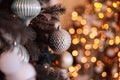 Close up view of beautiful fir branches with shiny golden bauble or ball, xmas ornaments and lights, Christmas holidays Royalty Free Stock Photo