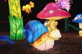 Close up view of the beautiful installation of pretty snail near fabulous plants and mushrooms. Royalty Free Stock Photo