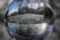 Close up view on beautiful landscape trees in blue sky through lens ball sphere in selective color, france Royalty Free Stock Photo