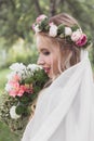 close-up view of beautiful smiling young bride in veil holding Royalty Free Stock Photo