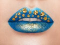 Close up view of beautiful woman lips with blue lipstick